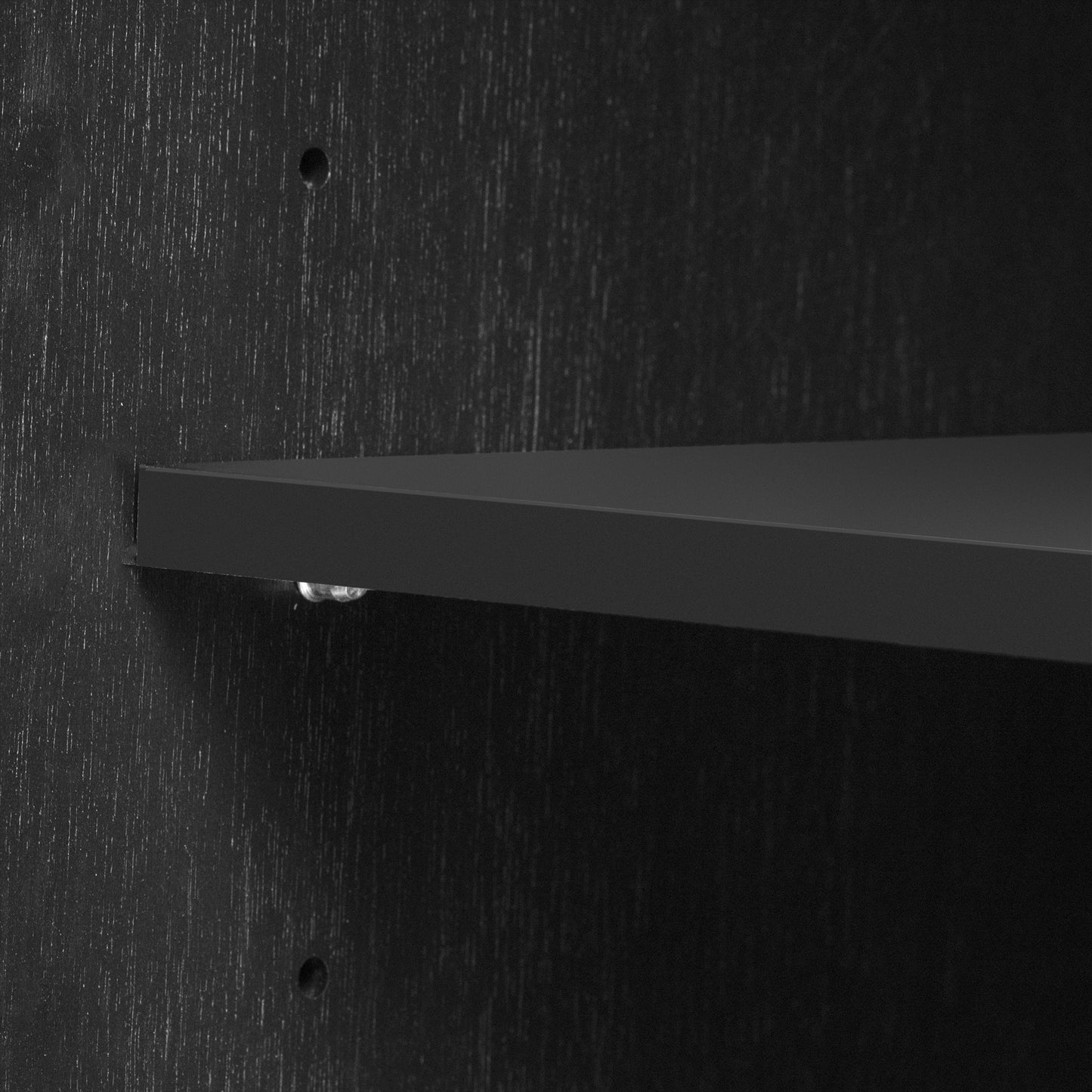 Closeup of a dark oak wood grain textured shelf support bracket