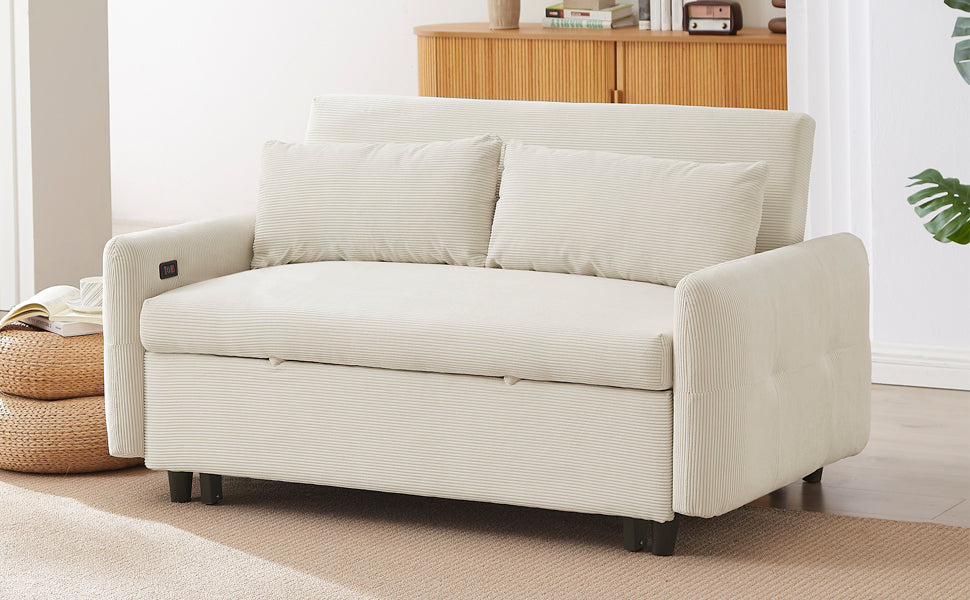 Cream corduroy convertible sofa bed with two throw pillows on a living room floor