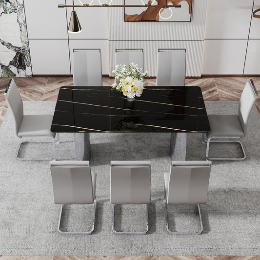 Modern dining set with a black marble effect table and grey upholstered chairs