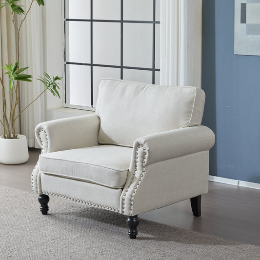 Light beige upholstered armchair with studded arms and dark wood legs for living room seating