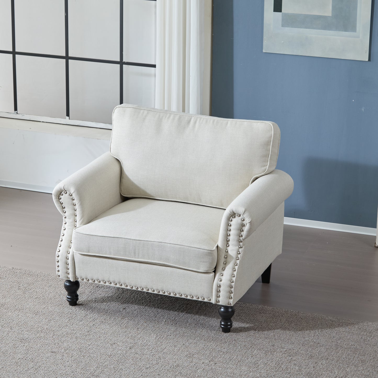 Elegant beige linen armchair with antique brass nailhead trim and dark wooden legs