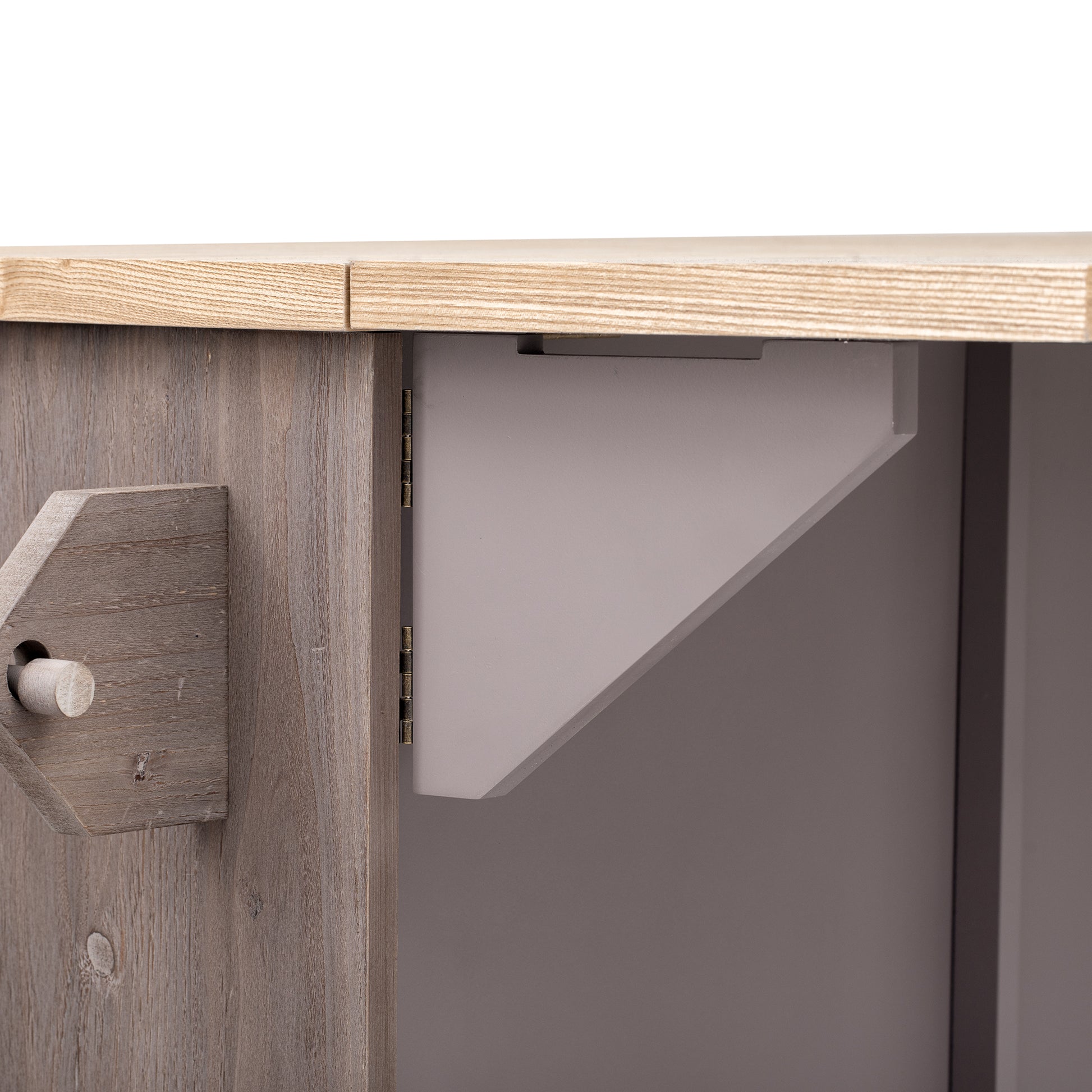 Rustic grey wooden cabinet door detail with a decorative peg and visible grain for farmhouse decor