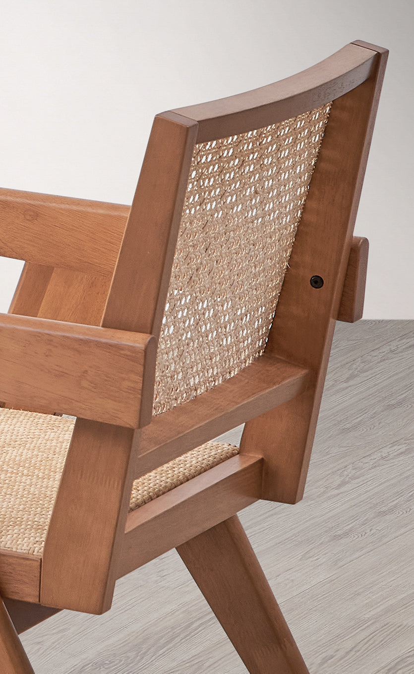 Modern armchair with natural wood frame and cane webbing backrest