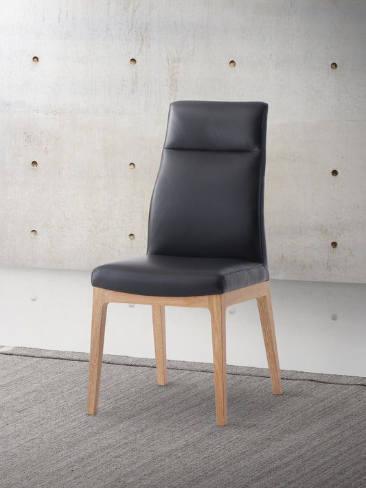 Black leather dining chair with light wood legs