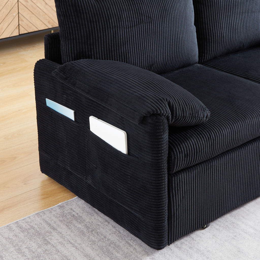 Black corduroy sofa with side pockets for tablets and magazines