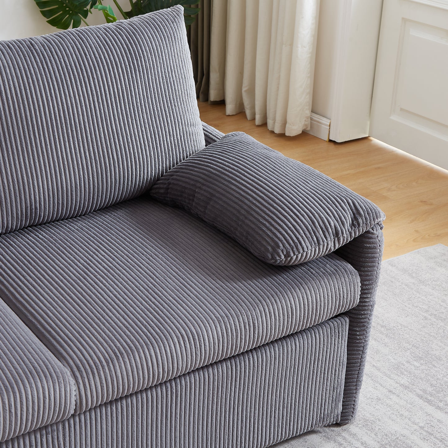 Grey corduroy sofa with plush cushions perfect for living room seating