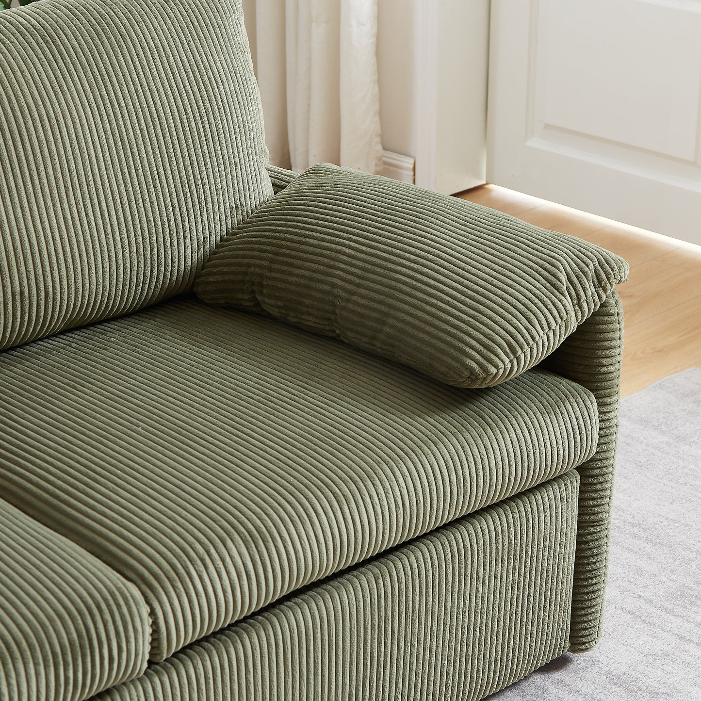 Sage green corduroy sofa with plush cushions a modern living room accent
