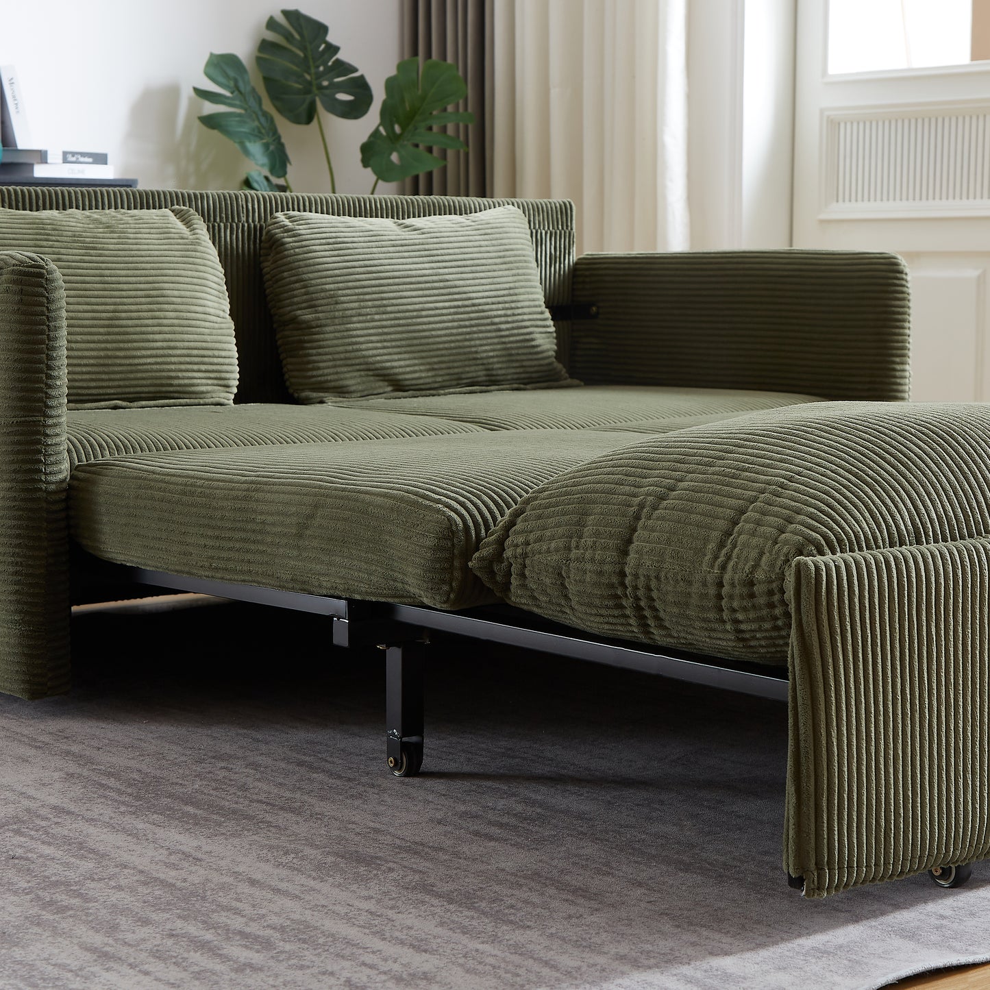 Green corduroy sofa bed with thick ribbed texture and plush cushions contemporary design