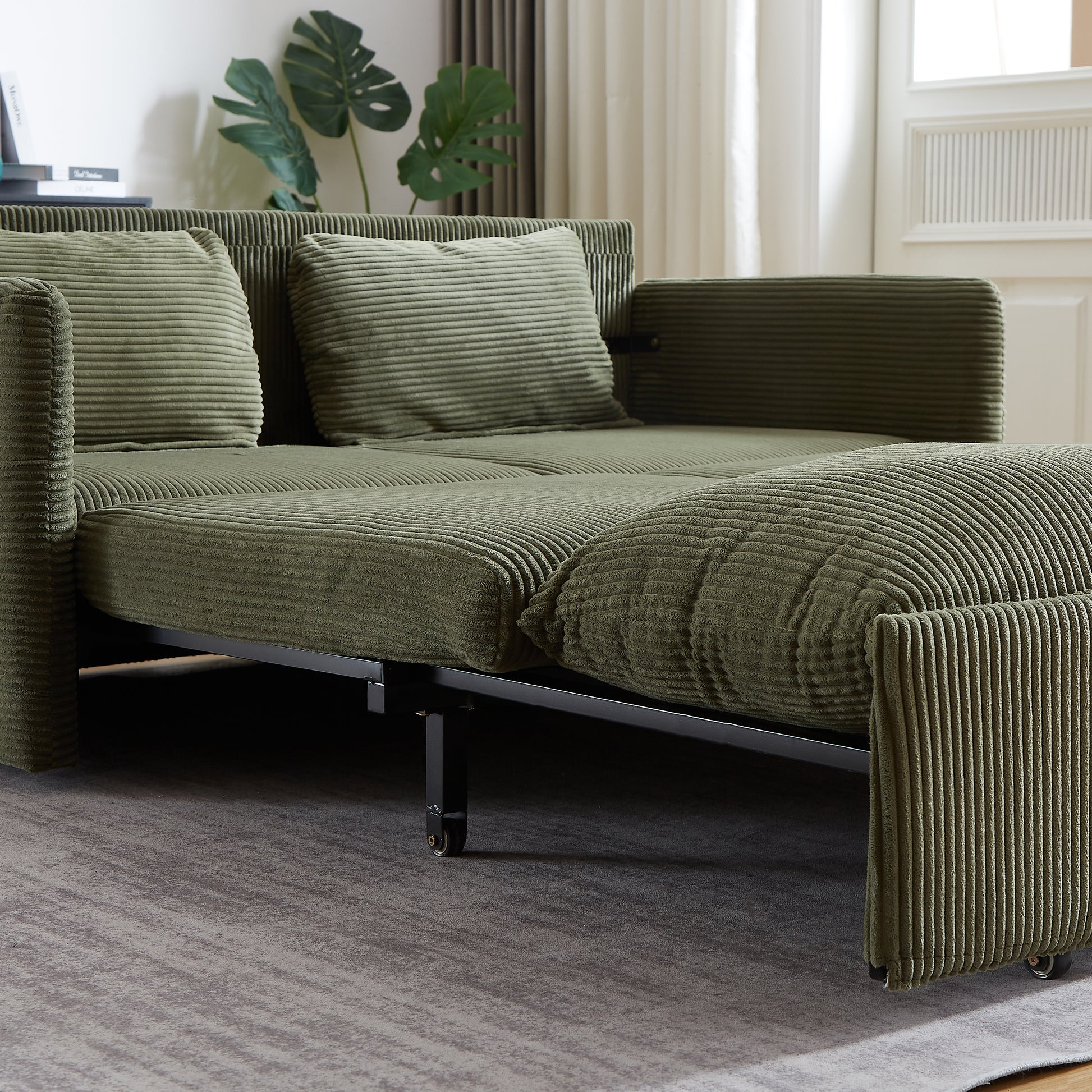 Green corduroy sofa bed with thick ribbed texture and plush cushions contemporary design