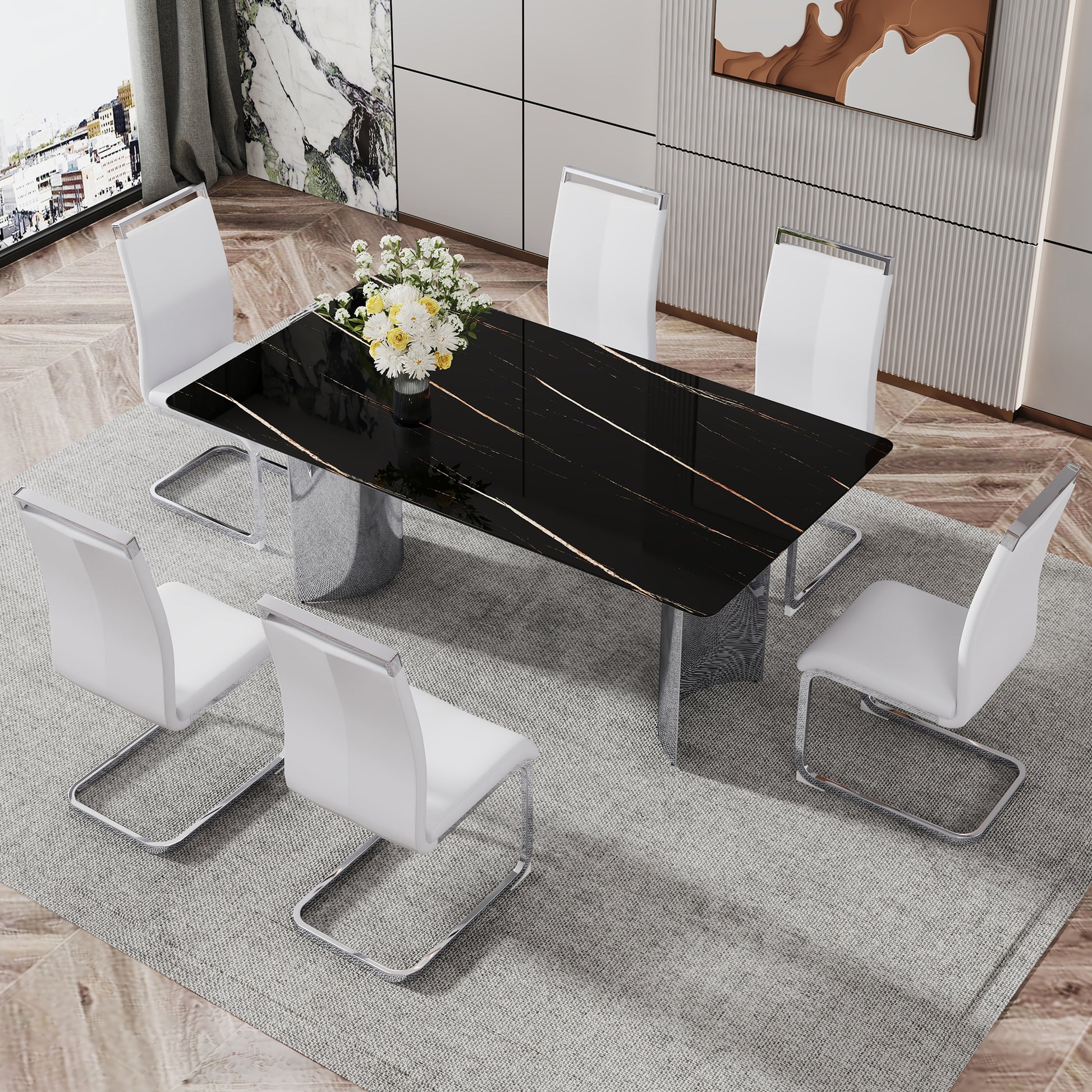 Sleek black marble dining table with gold veining paired with six white faux leather chairs