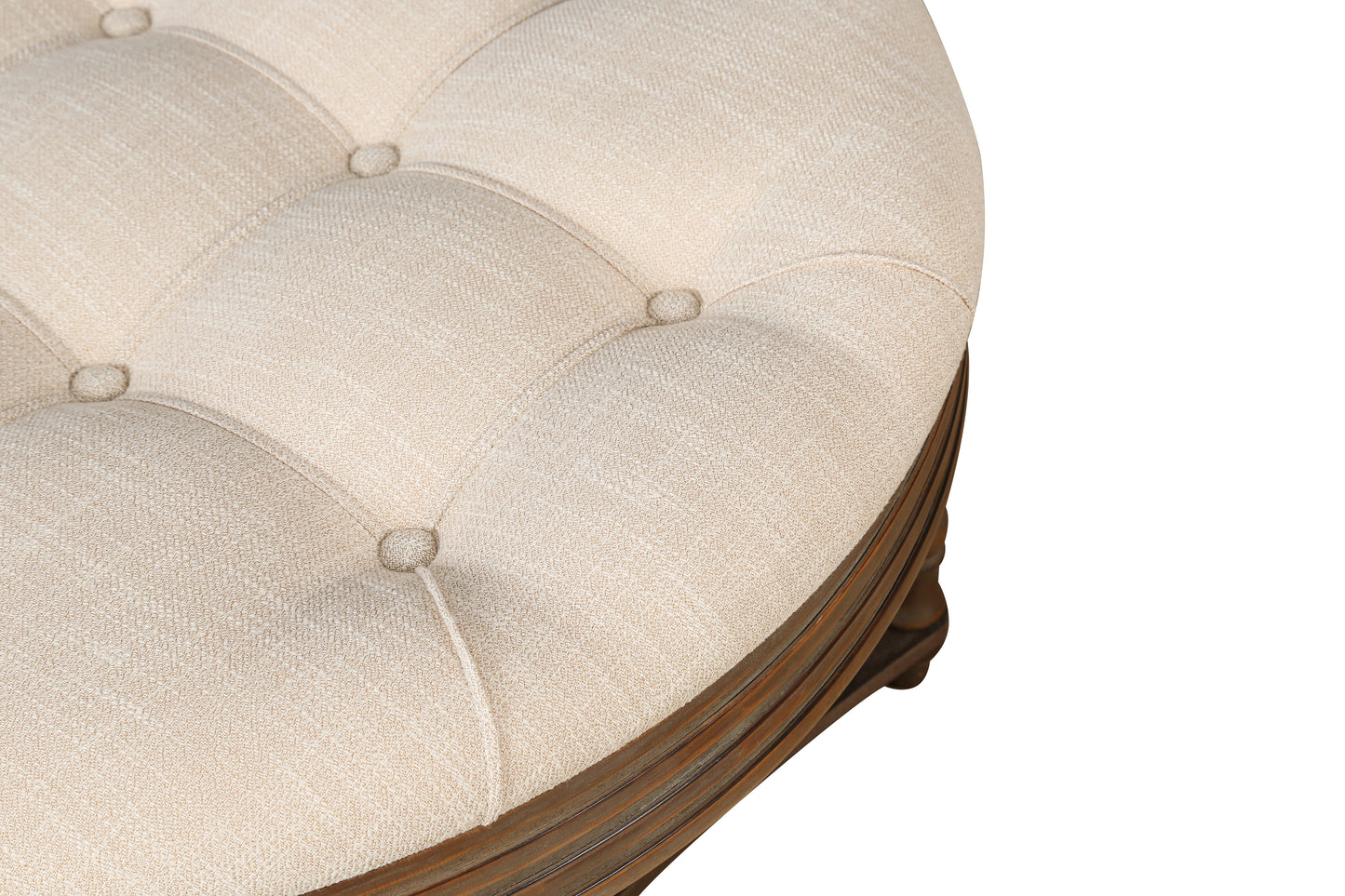 Tufted beige fabric ottoman with carved wooden base for elegant living room accent