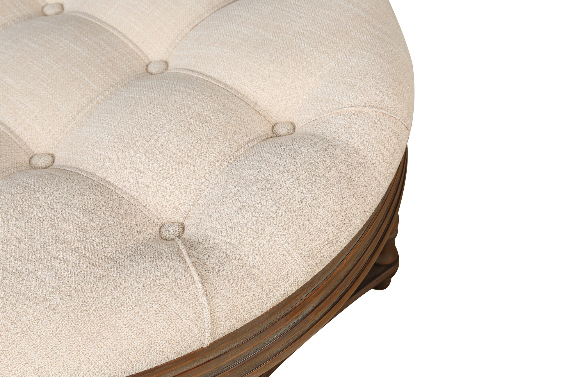 Tufted beige fabric ottoman with carved wooden base for elegant living room accent