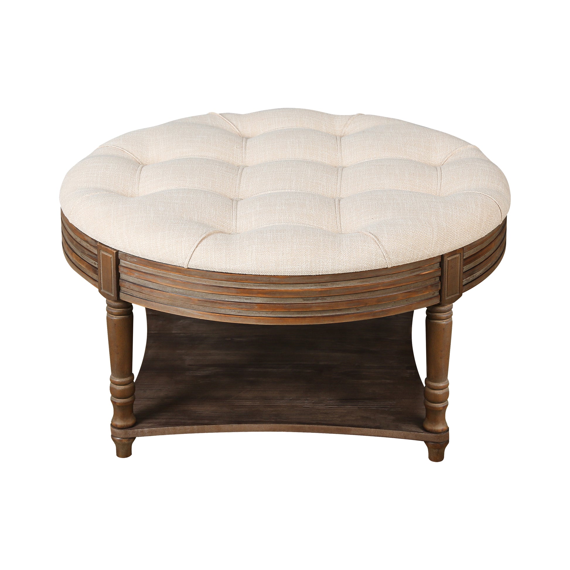 Tufted round ottoman in cream linen with dark wood base and shelf