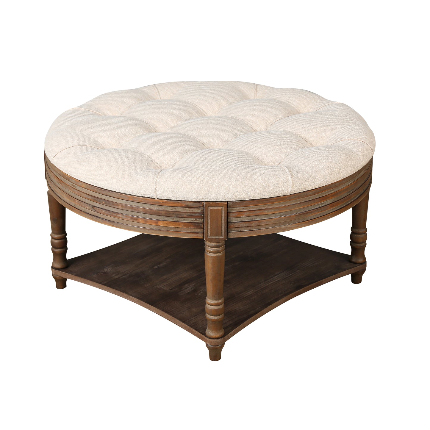 Tufted round ottoman with beige fabric upholstery and a distressed wood base perfect for a living room coffee table