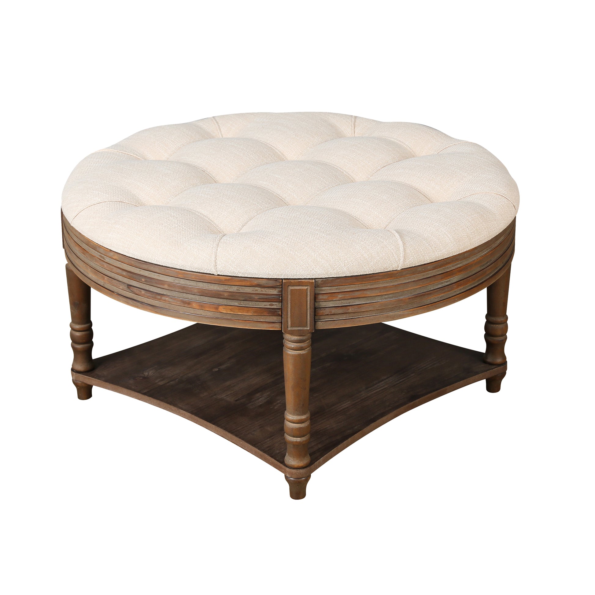 Tufted round ottoman with beige fabric upholstery and a distressed wood base perfect for a living room coffee table