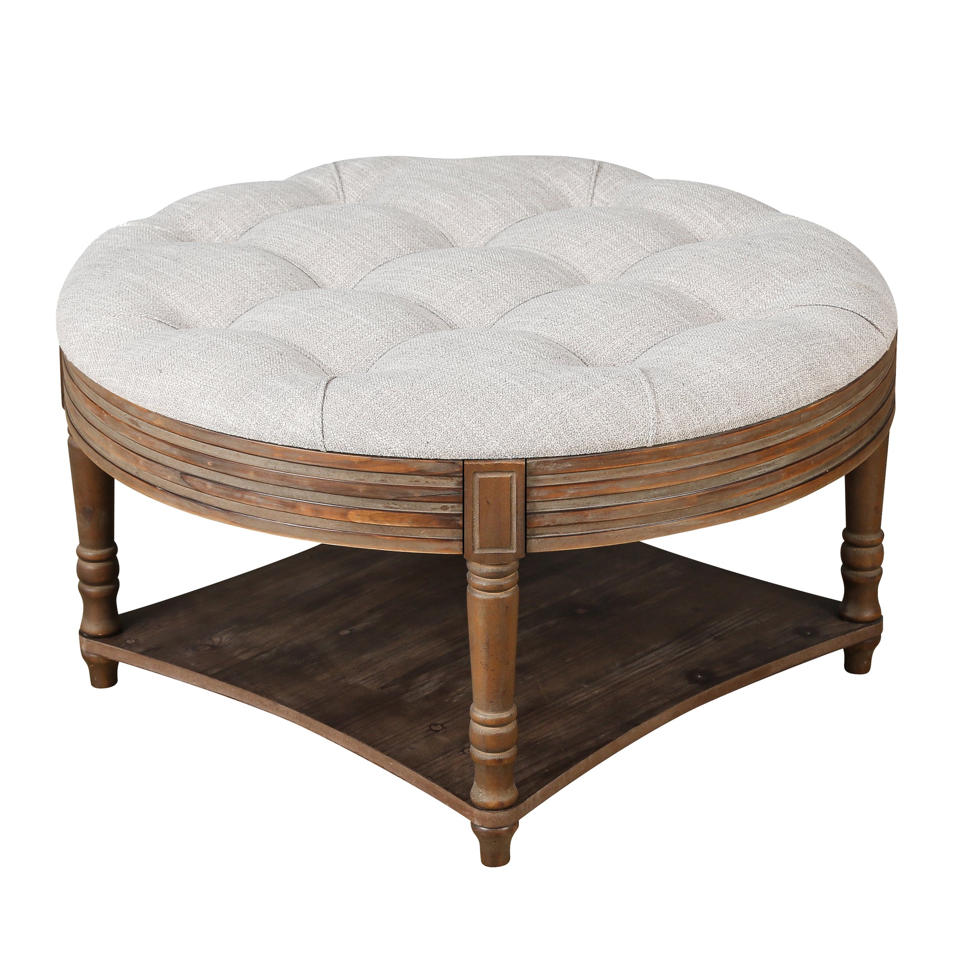 Tufted round ottoman with grey linen upholstery and a distressed wood base perfect for living rooms