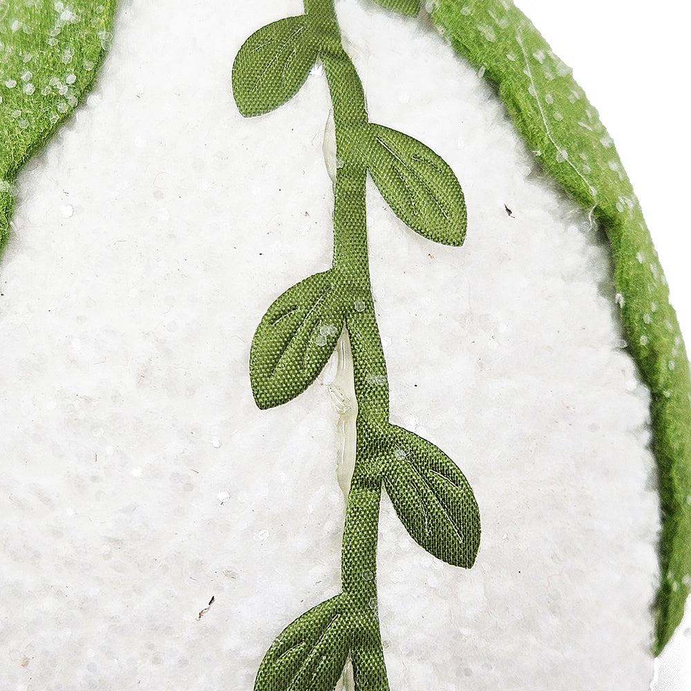 Green fabric leaf vine applique on white textured background crafted for decor