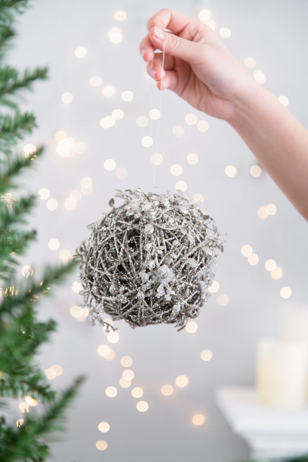 Silver glittery twig ball ornament with faux snow detail ideal Christmas decoration