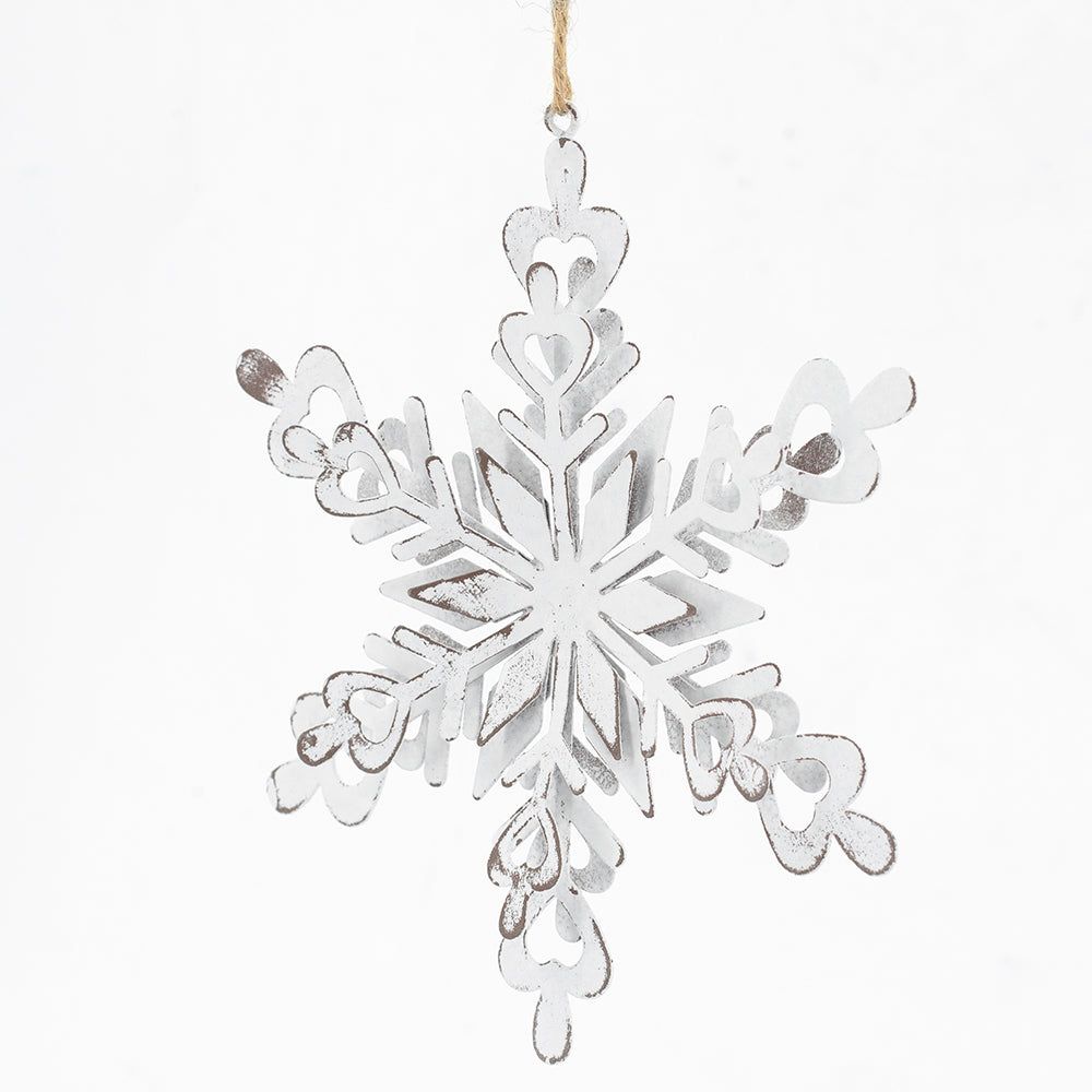Distressed white metal snowflake ornament with heartshaped accents perfect for winter decor