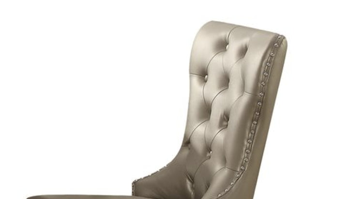 Champagne velvet dining chair with button tufting and nailhead trim