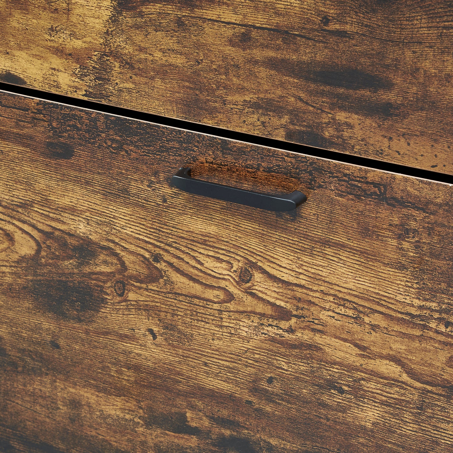 Closeup of rustic brown wood grain dresser drawer with black metal handle