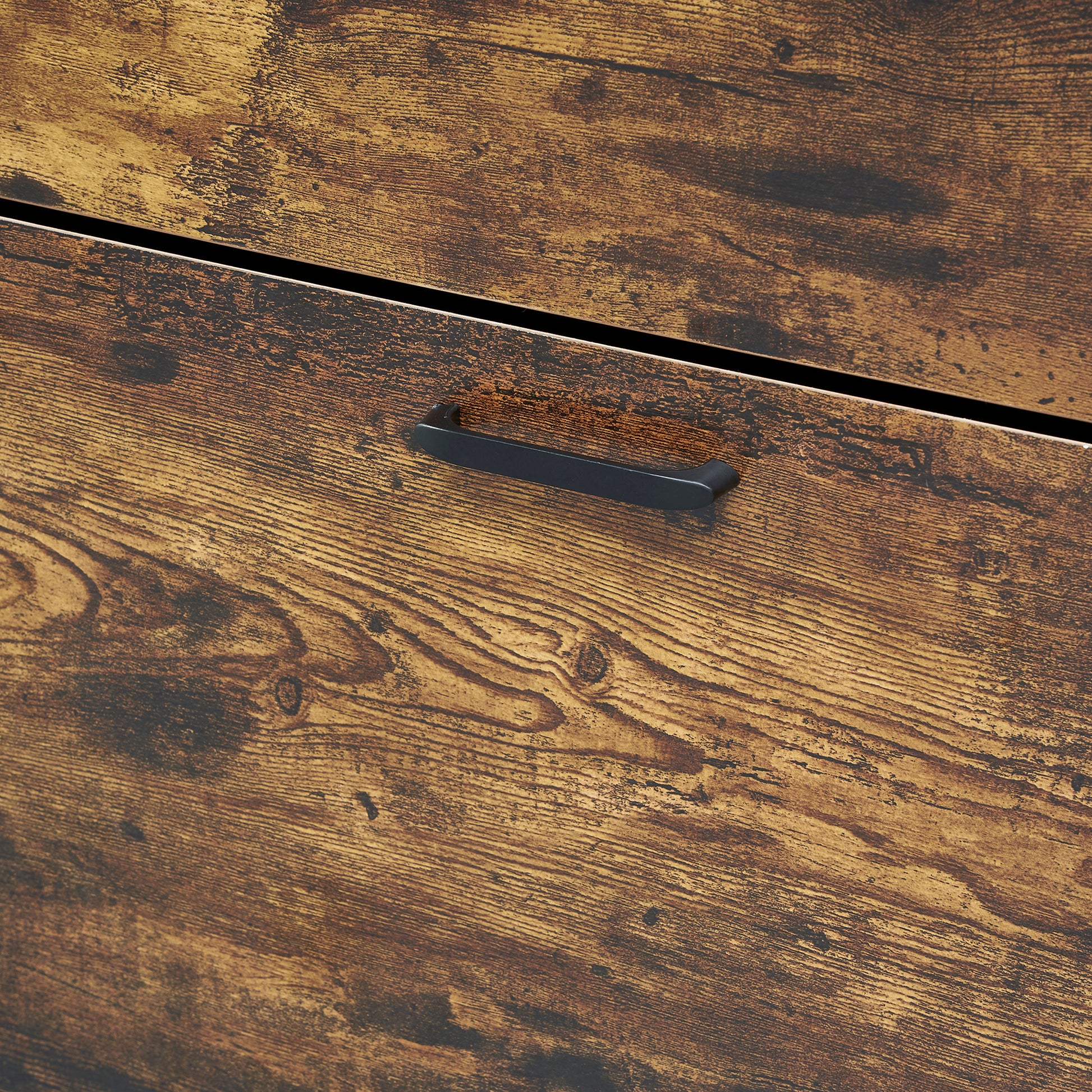Closeup of rustic brown wood grain dresser drawer with black metal handle