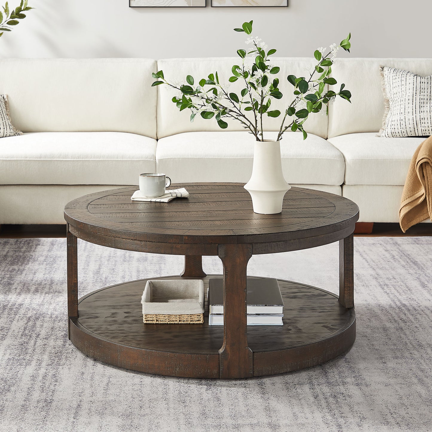 Dark wood round coffee table with lower shelf and textured tabletop