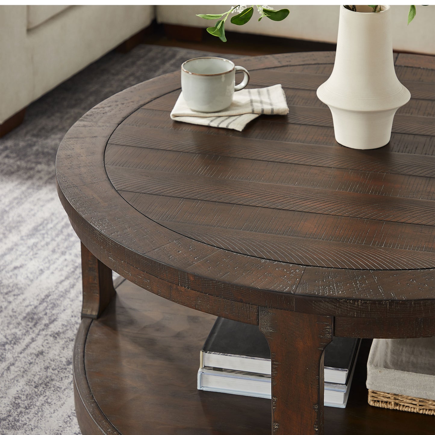 Rustic dark wood round coffee table with planked surface and lower shelf  characters