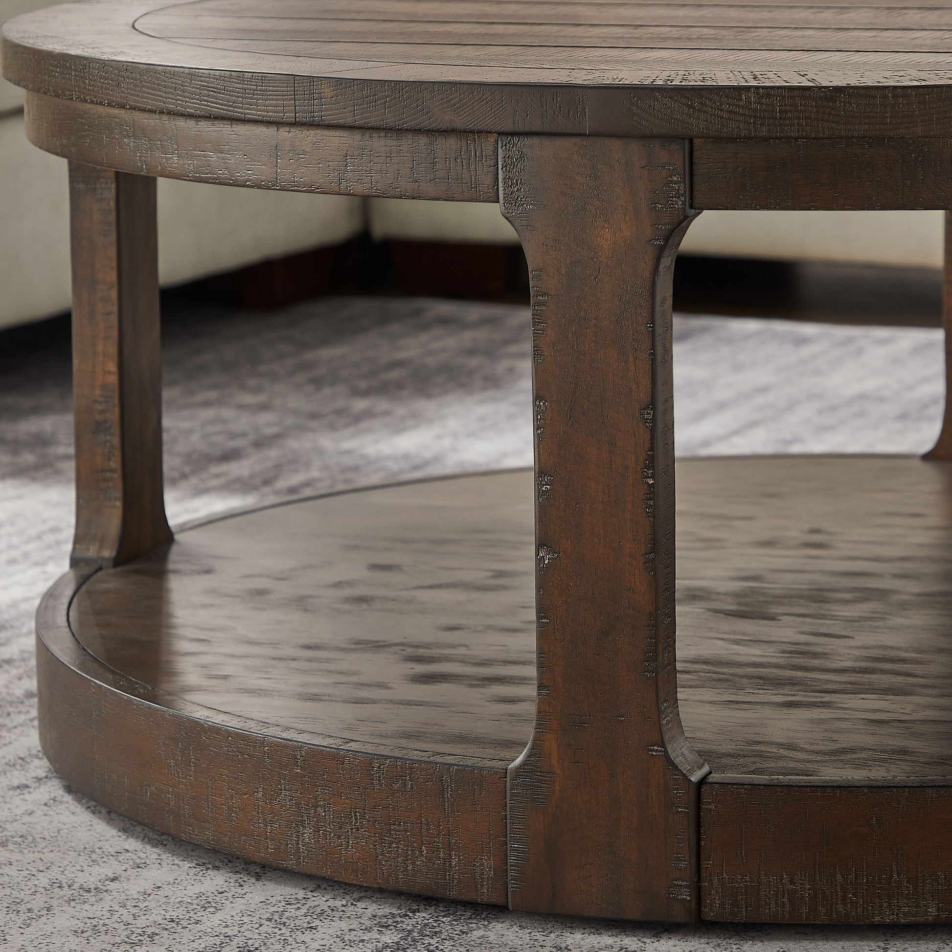 Rustic dark wood round coffee table with a textured finish and lower shelf