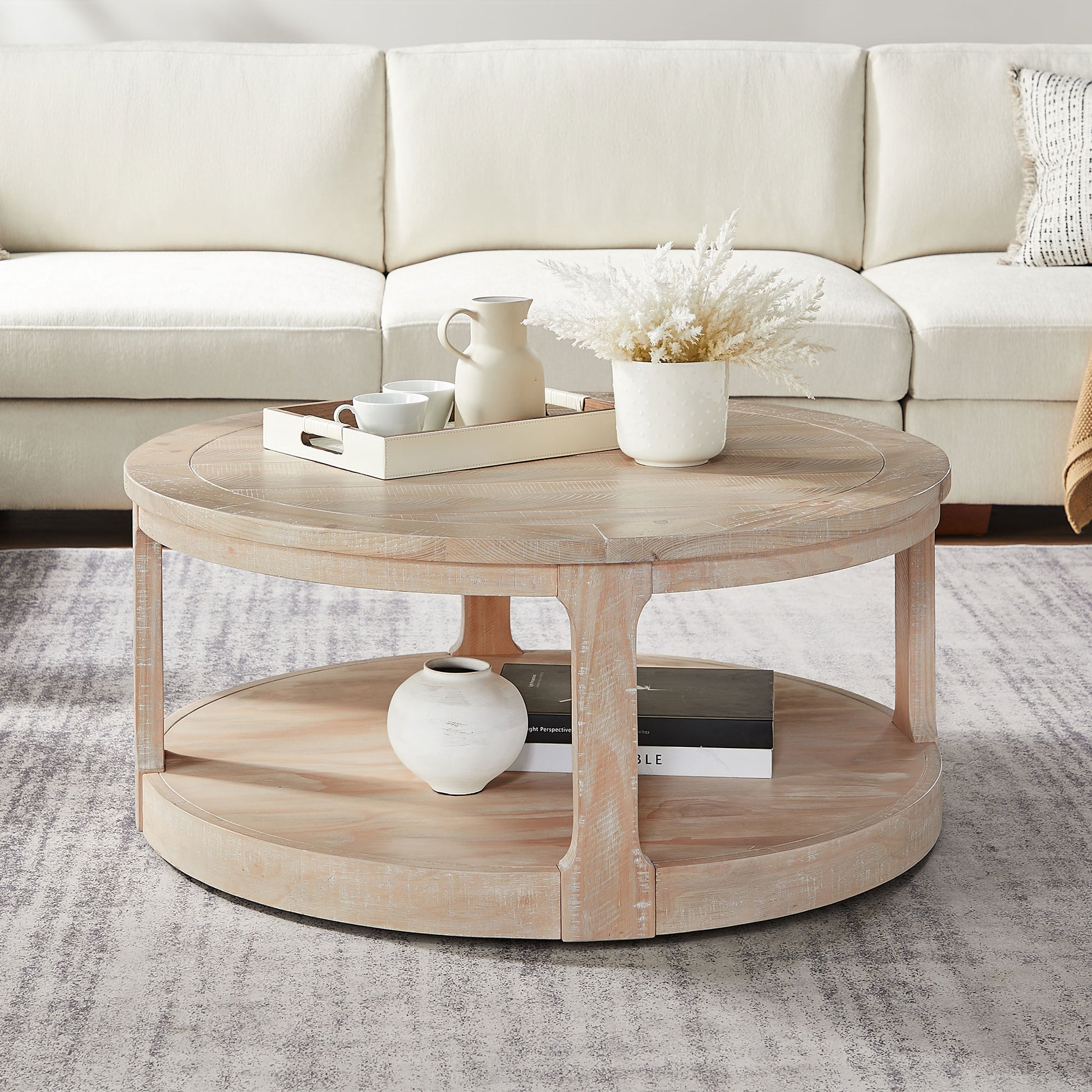 Round distressed wood coffee table with two tiers and decorative items