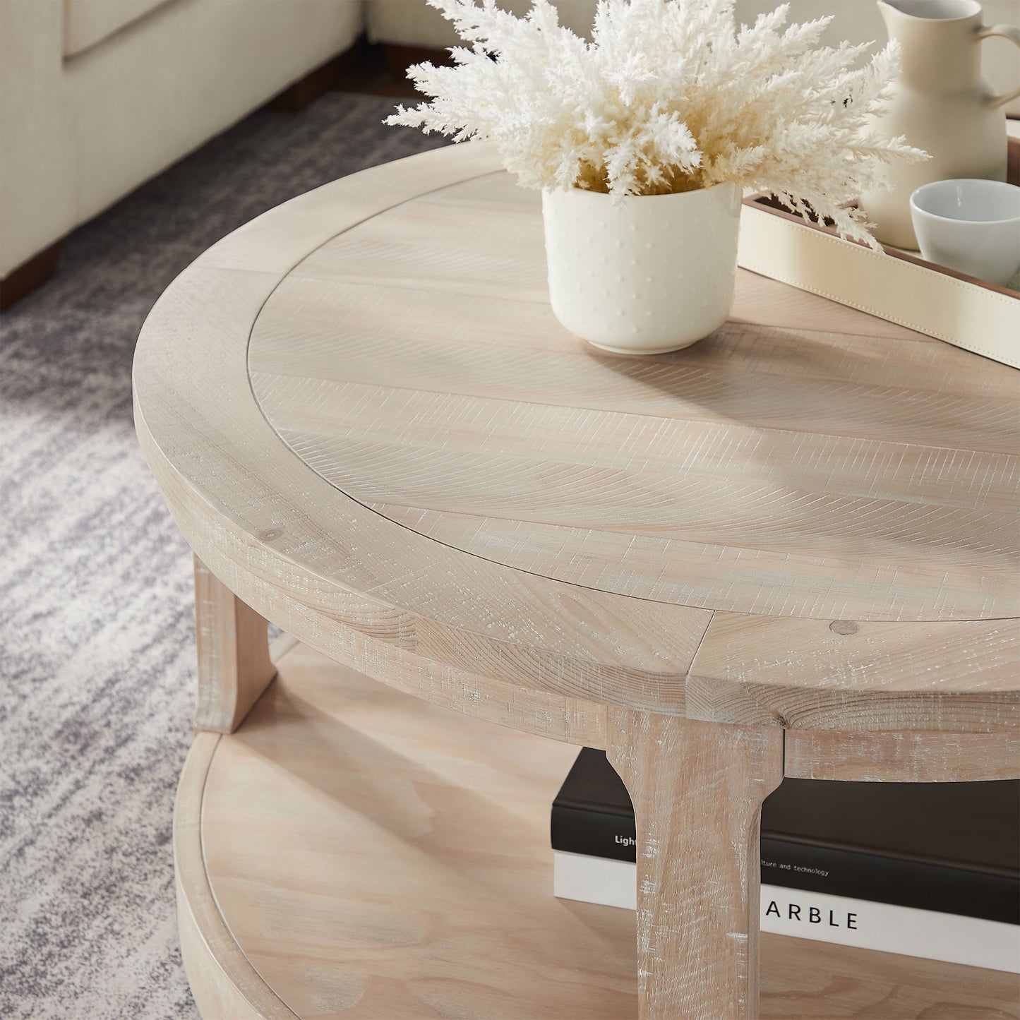Whitewashed wood round coffee table with textured top detail