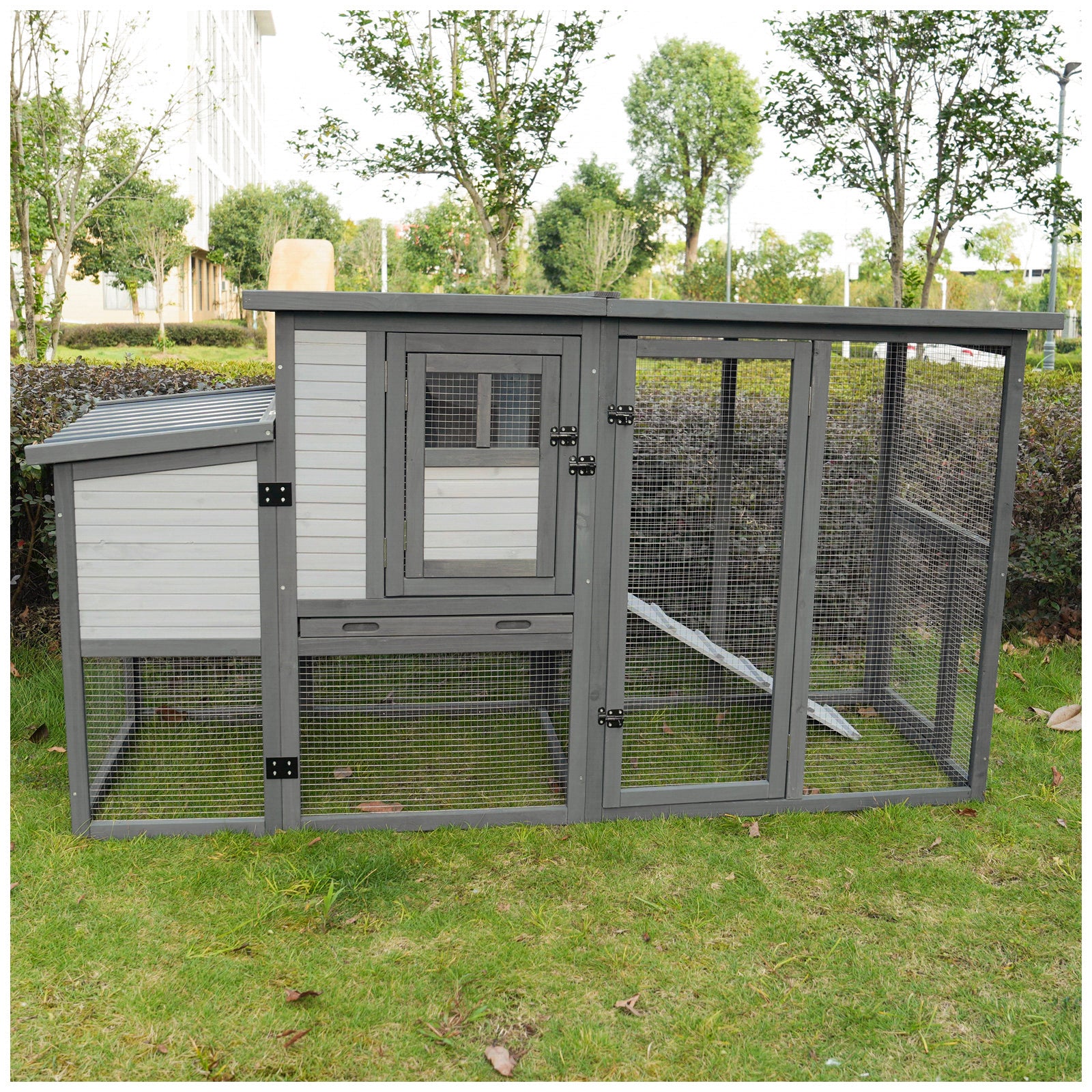 Wooden chicken coop with multiple compartments and wire mesh runs ideal for backyard flocks