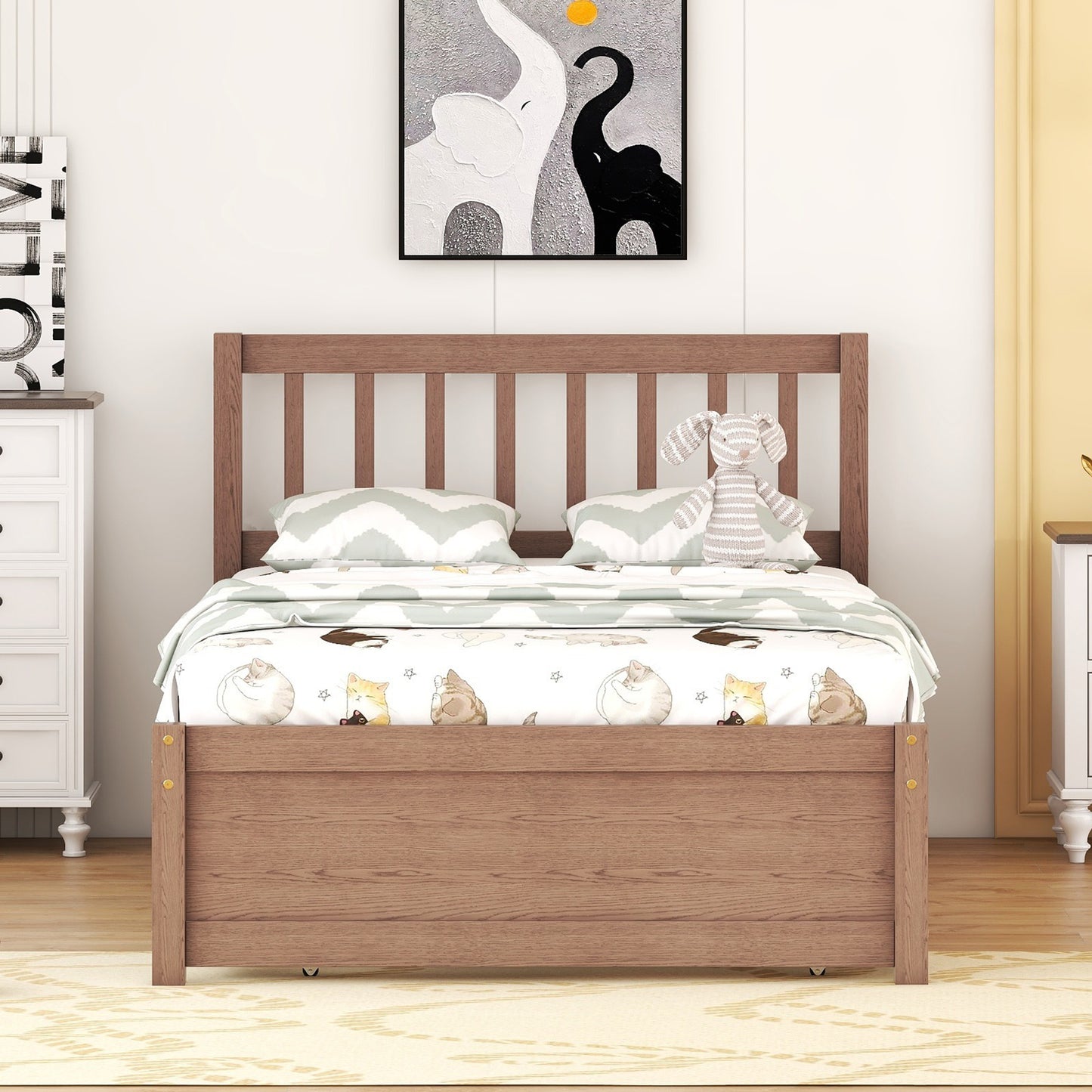 Wooden twin bed frame with playful catthemed bedding and chevron pillows
