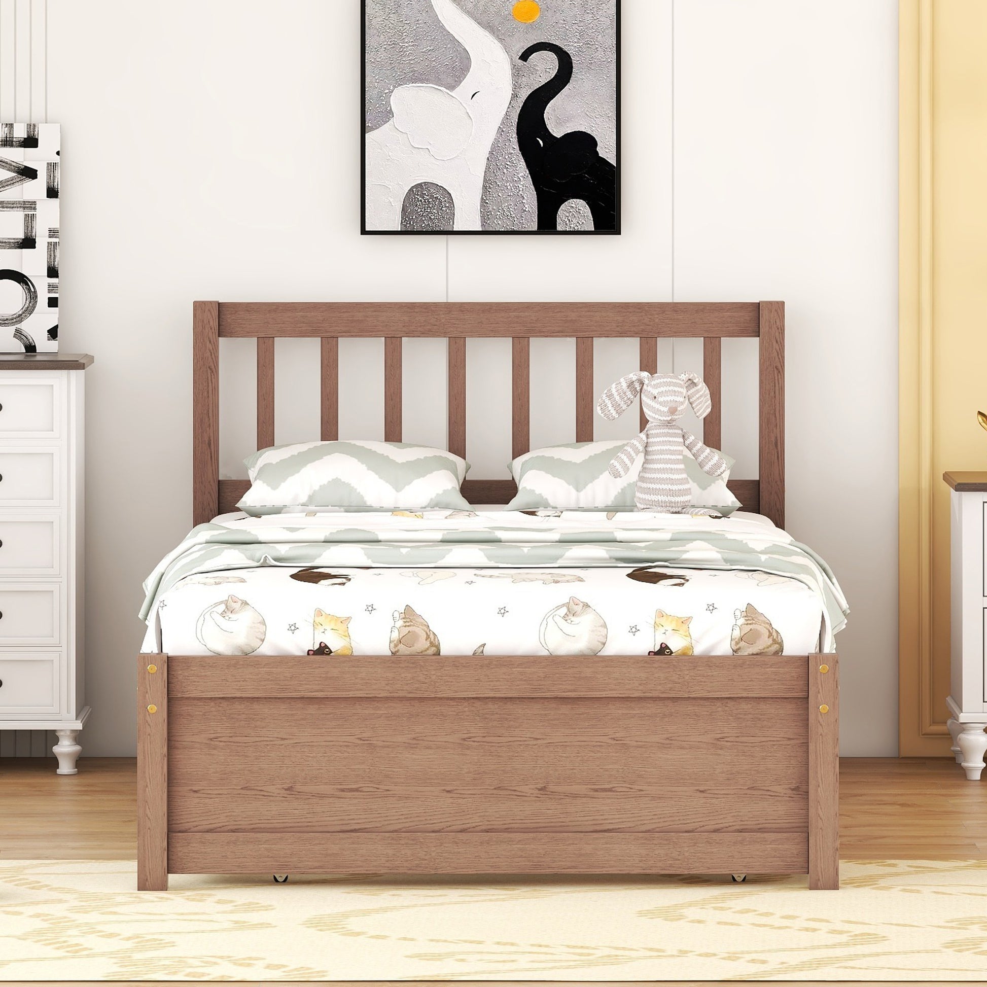 Wooden twin bed frame with playful catthemed bedding and chevron pillows
