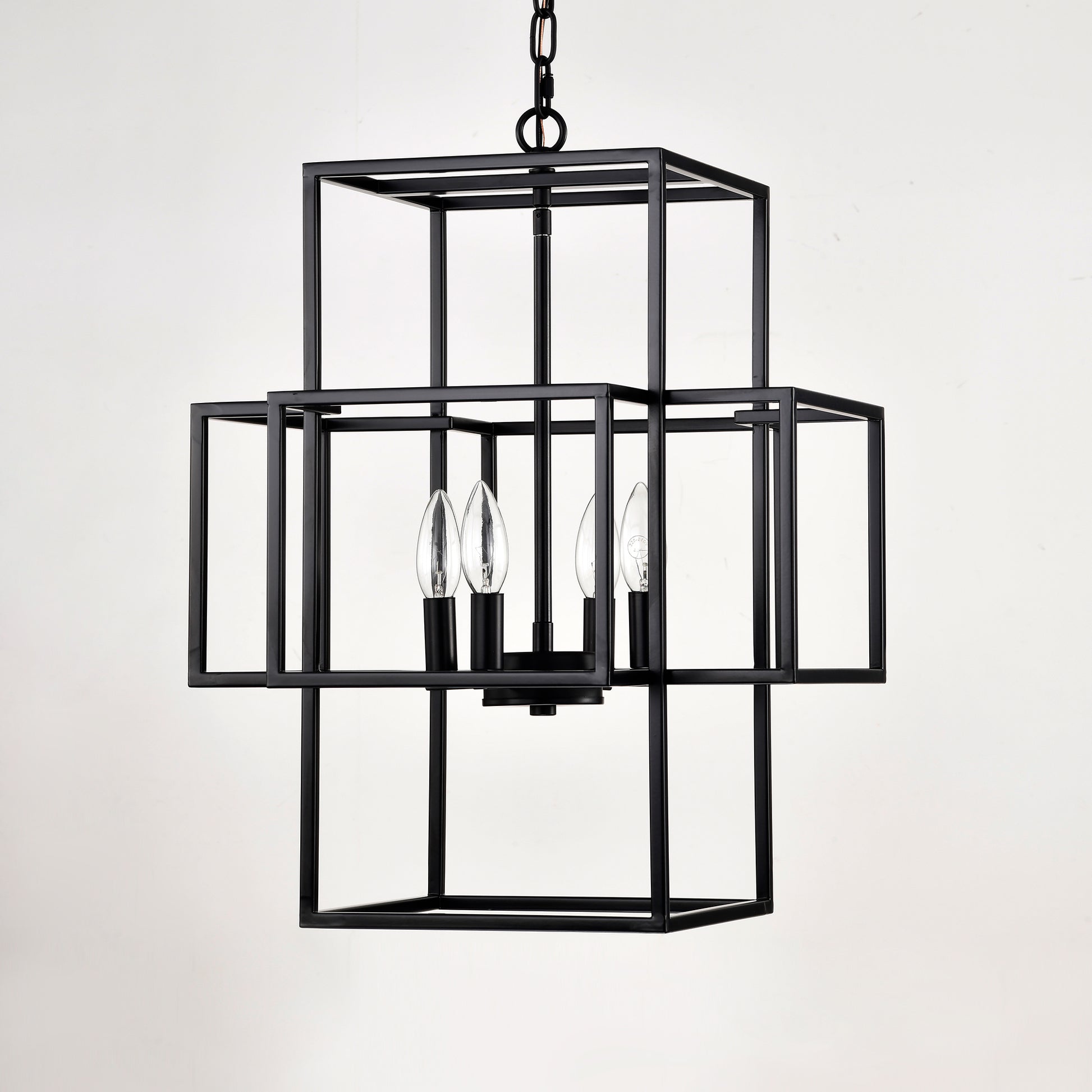 Modern black metal geometric chandelier with four clear candelabra bulbs for dining room lighting