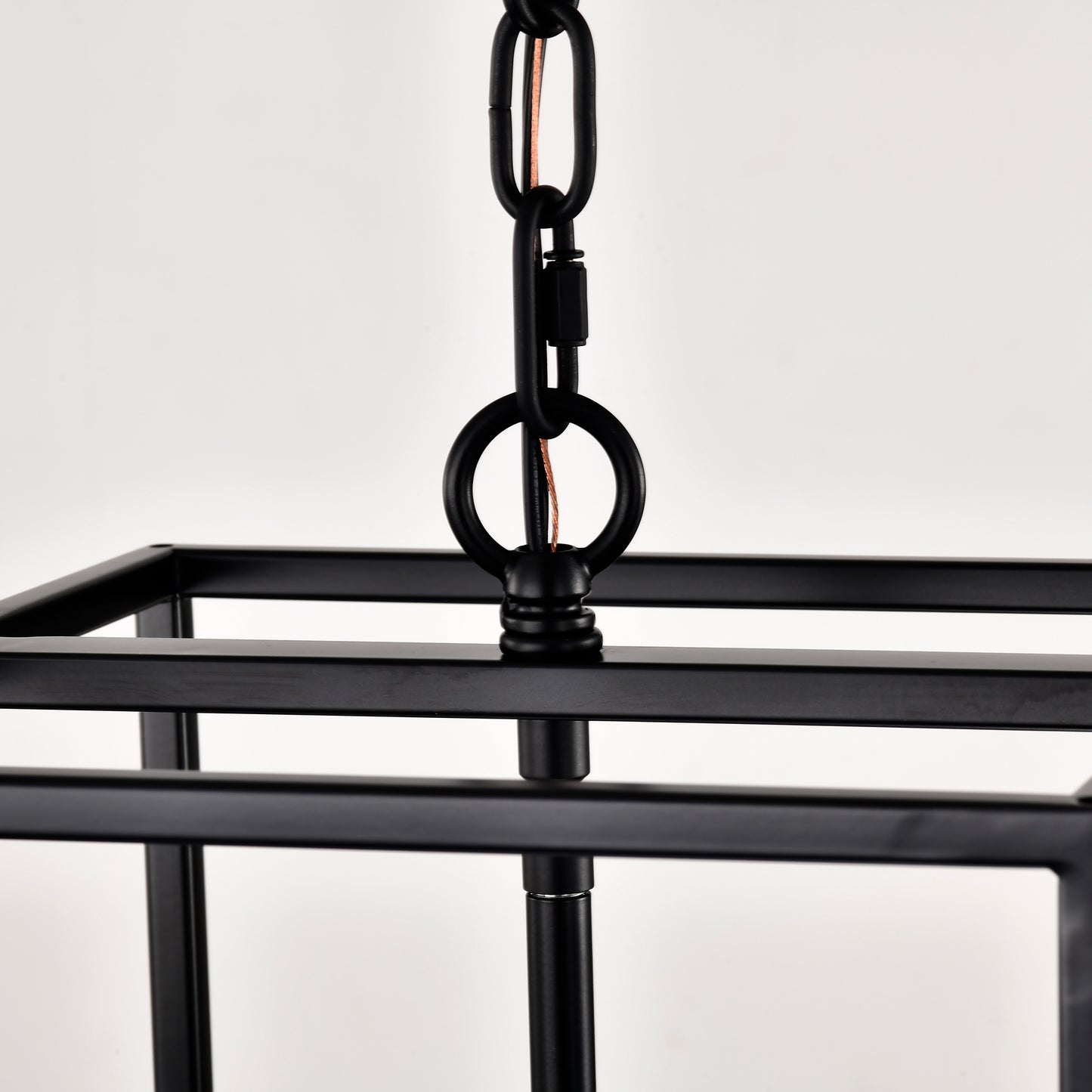 Closeup of a black rectangular cage chandelier with metal chain for hanging