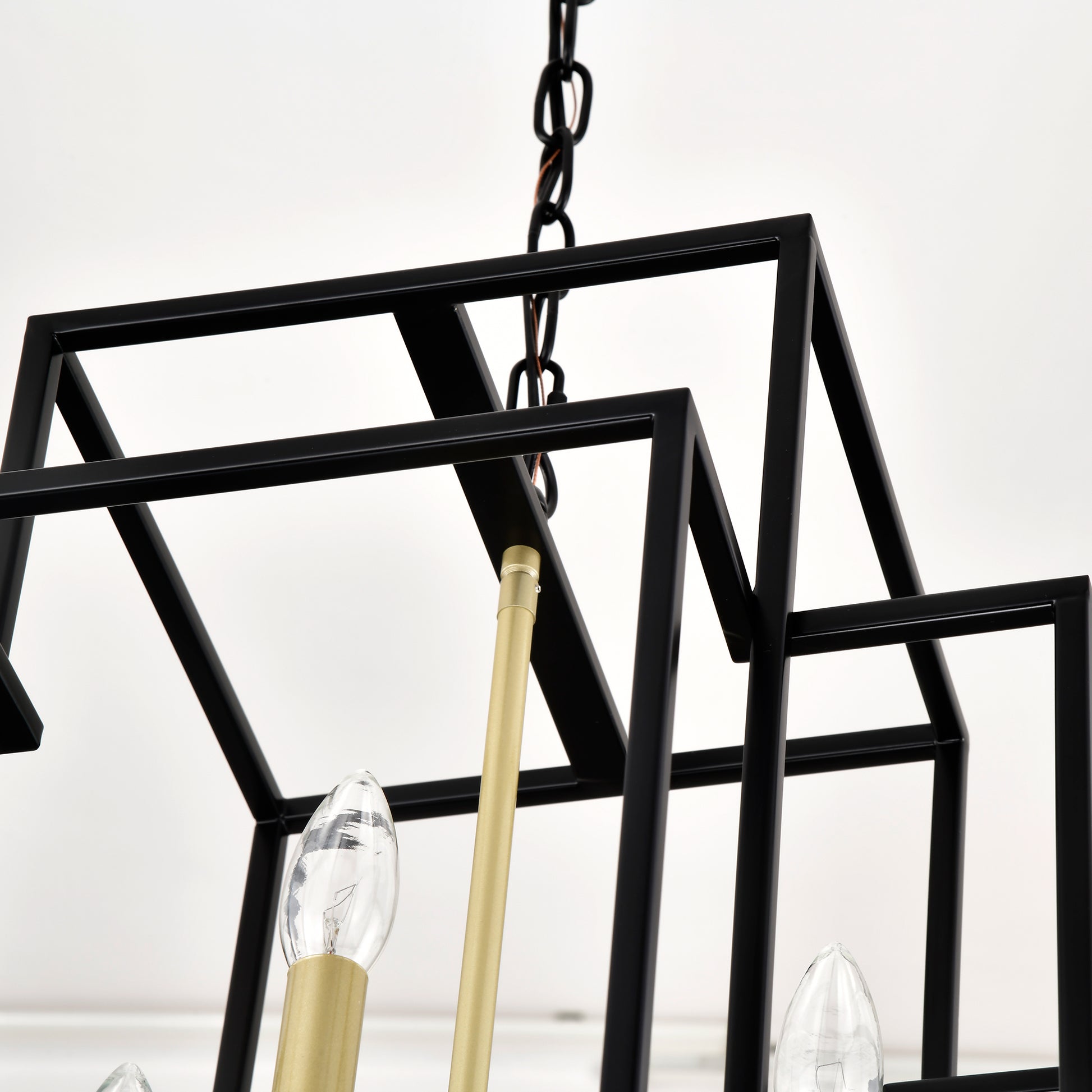 Geometric black metal chandelier with gold accents and clear bulbs