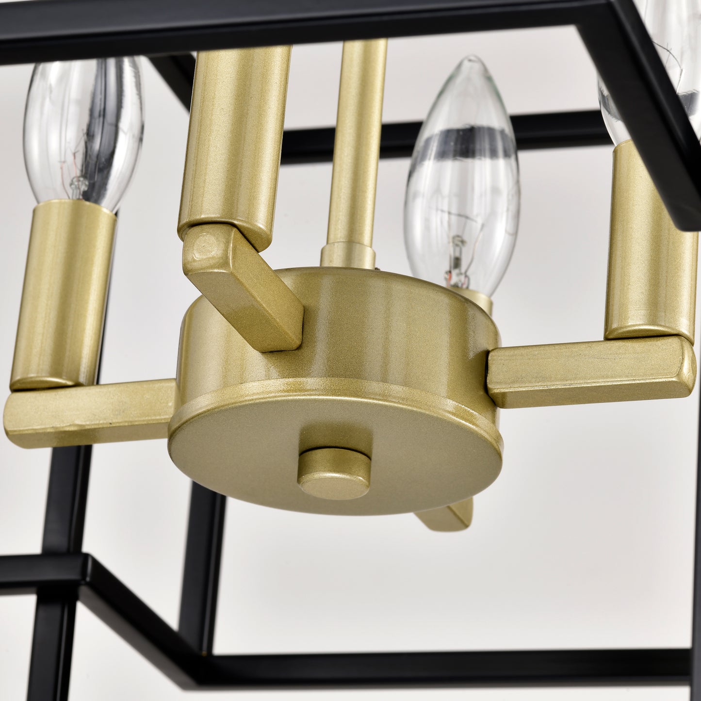 Close up of a gold and black geometric pendant light fixture featuring clear bulbs