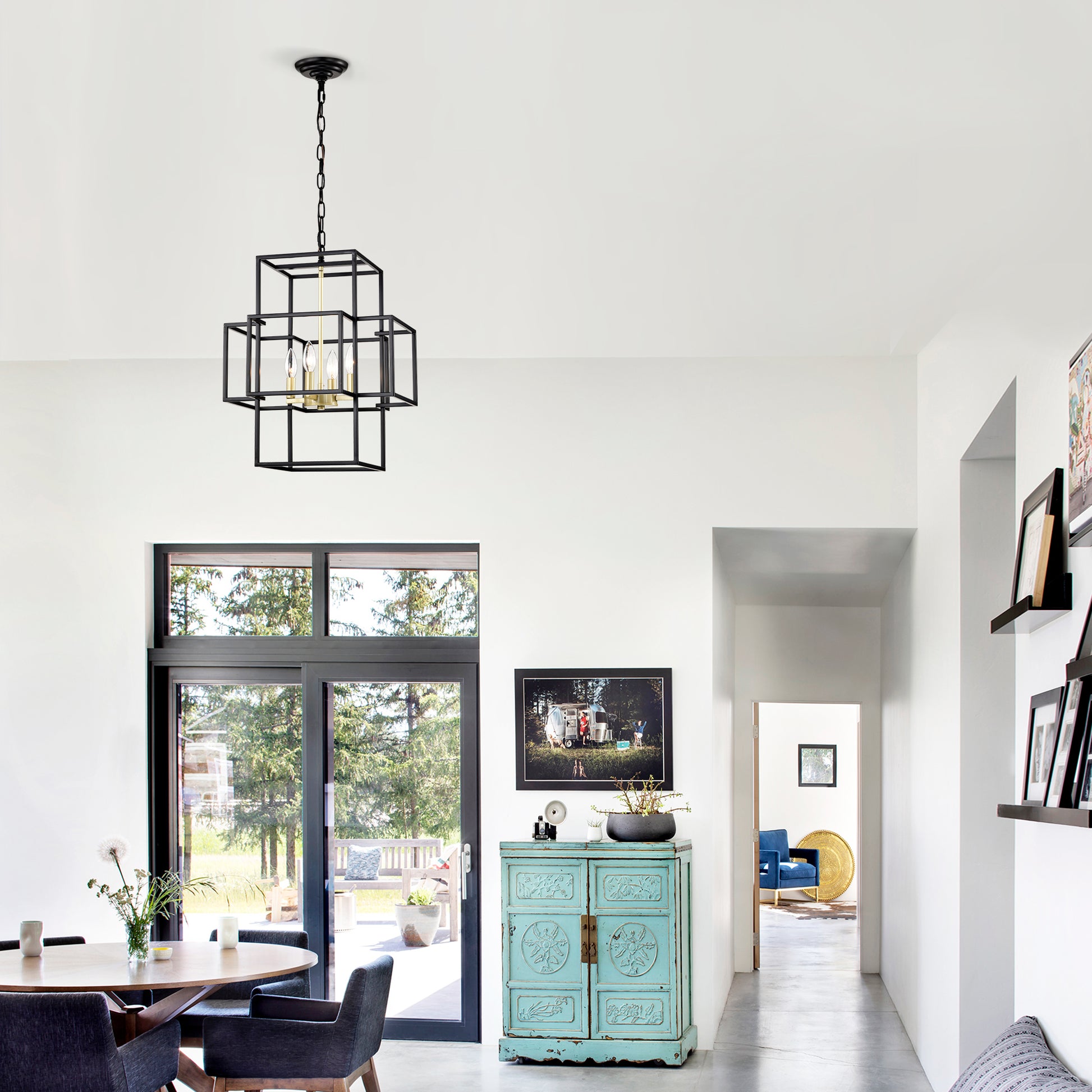 Geometric black metal chandelier with brass accents over dining table