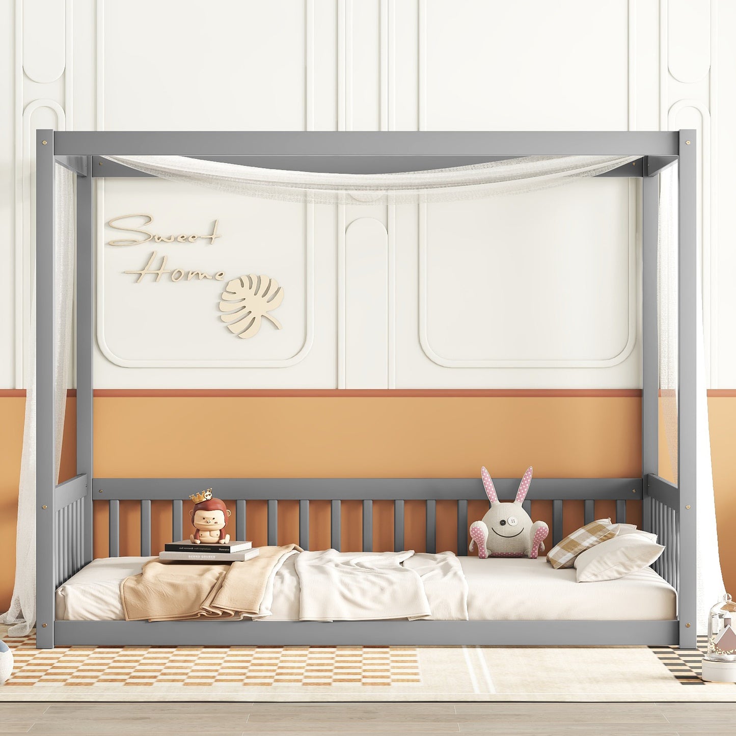 Gray wooden canopy bed frame with sheer curtains and plush toys