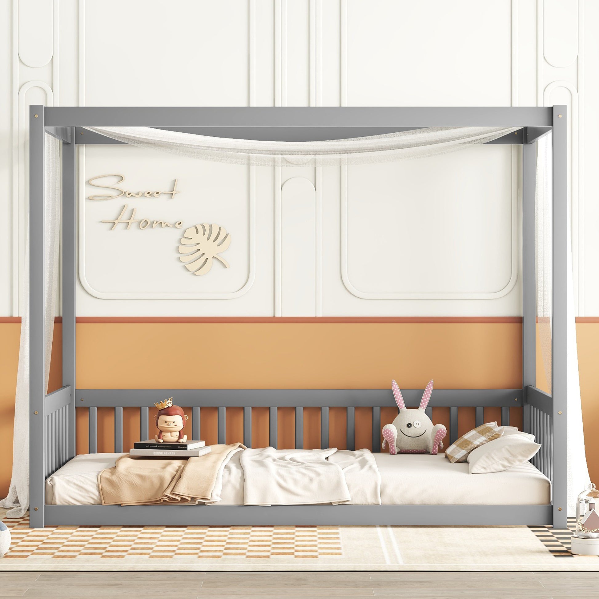 Gray wooden canopy bed frame with sheer curtains and plush toys