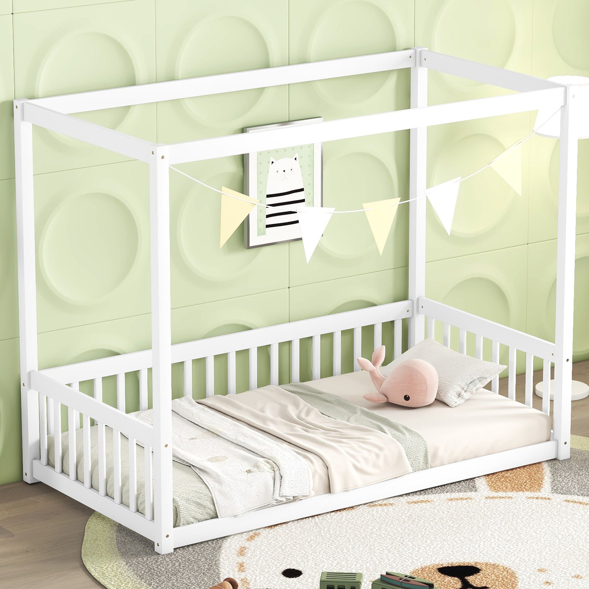 White wooden canopy bed with safety rails and bedding for nursery