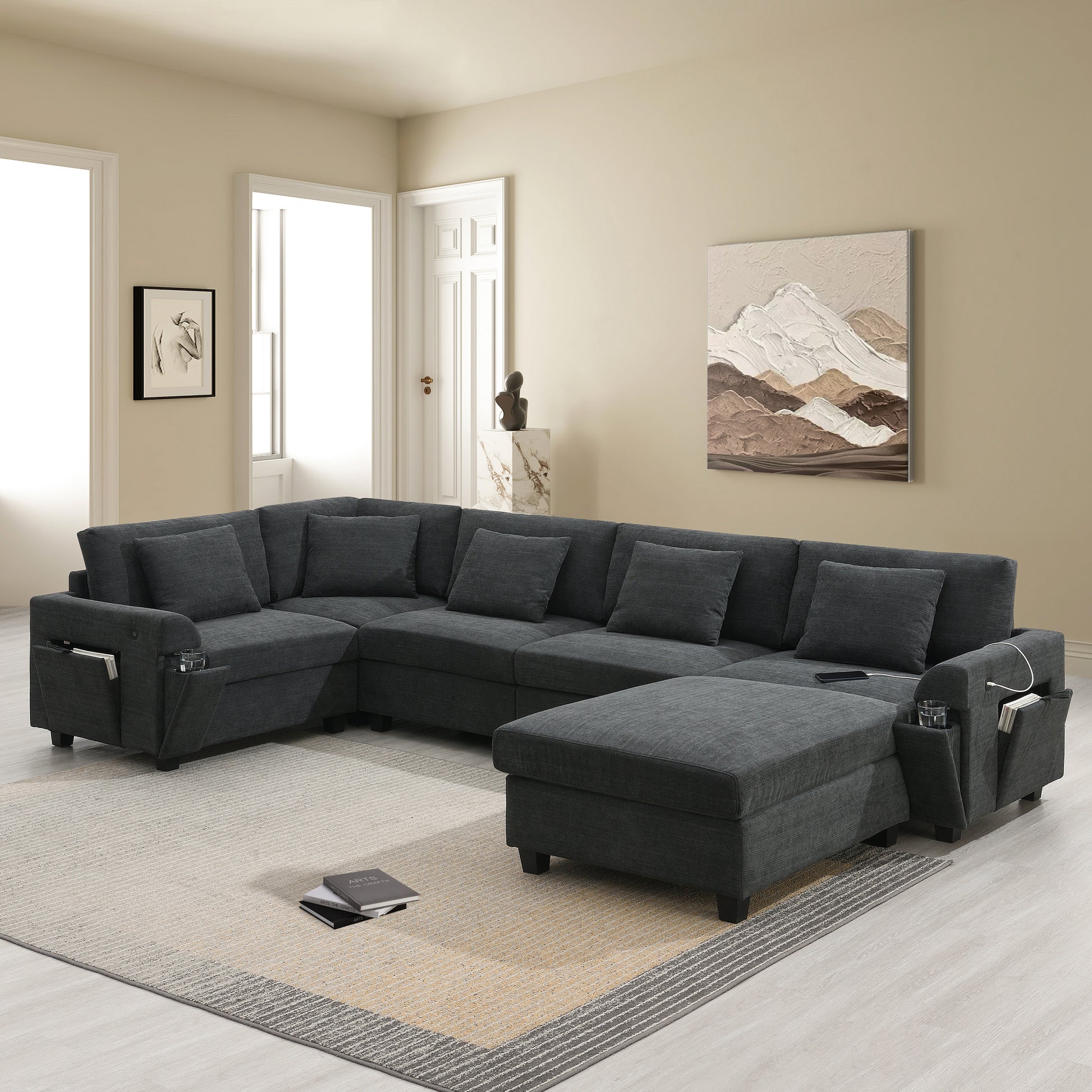 Dark gray sectional sofa with chaise and ottoman featuring builtin storage and cup holders