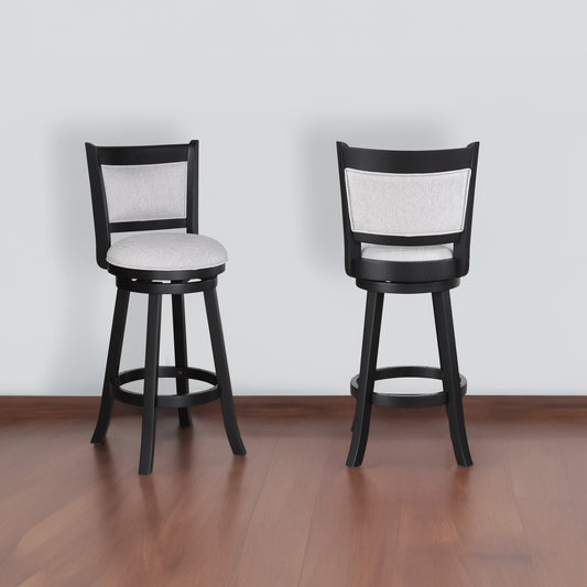 Two black swivel bar stools with light grey upholstered seats and backs