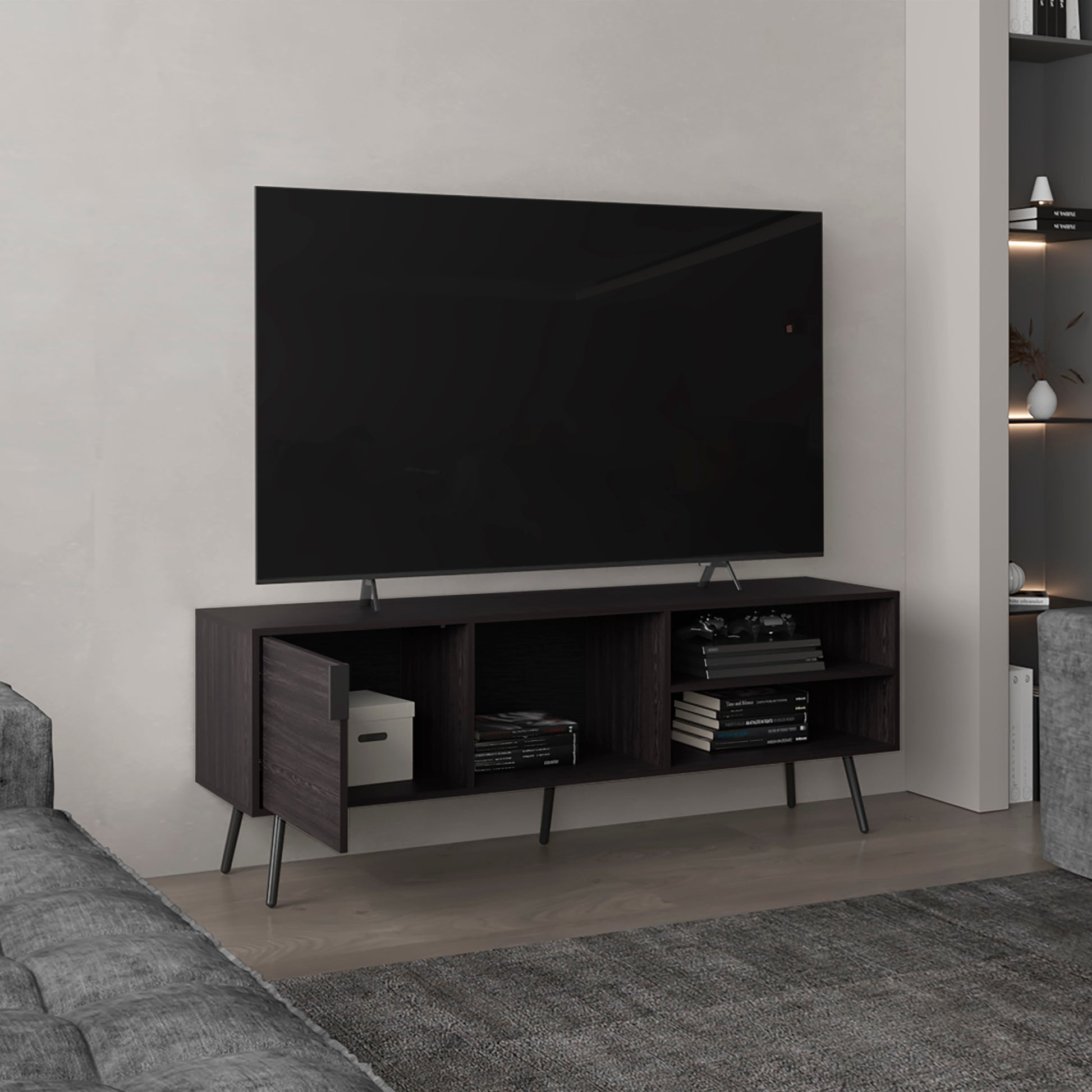 Dark wood TV stand with open shelving a closed cabinet and tapered legs