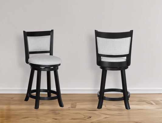 Black wooden swivel bar stool with light gray fabric seat and back