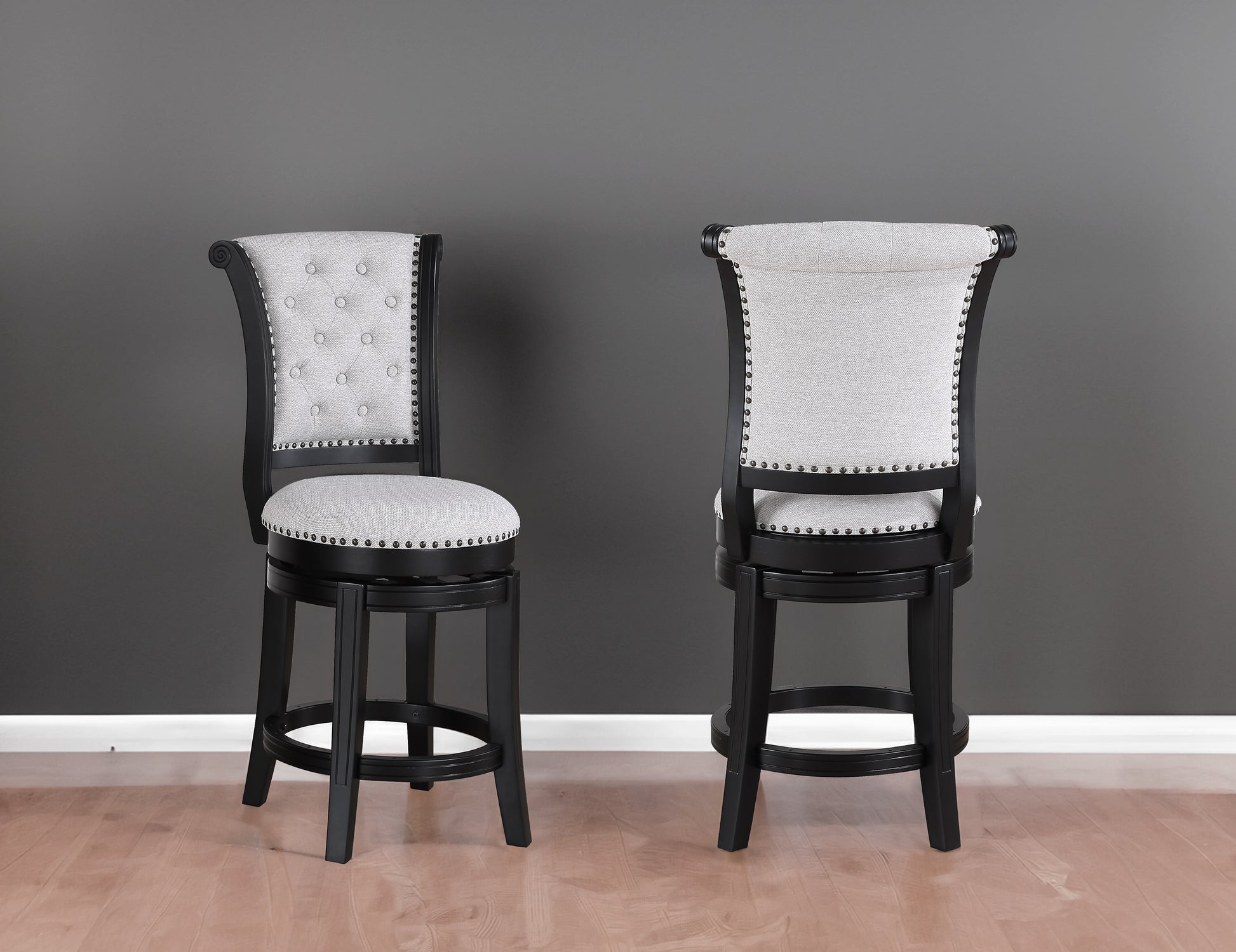 Elegant grey upholstered bar stool with nailhead trim and dark wood frame