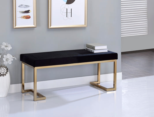 Black velvet bench with gold frame and modern design