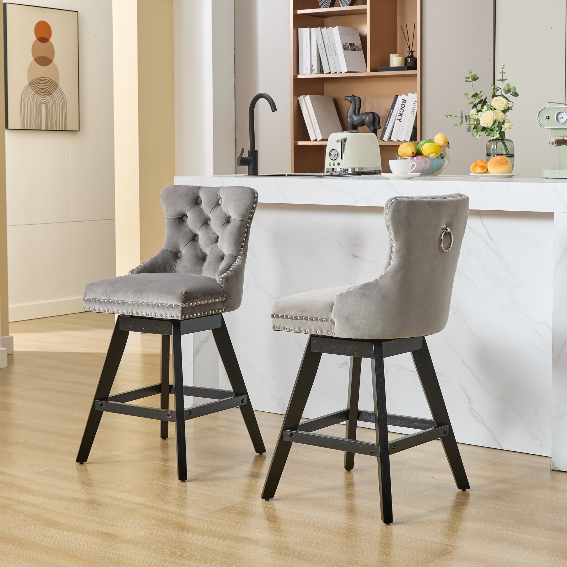 Grey velvet tufted swivel bar stool with silver nailhead trim and metal legs