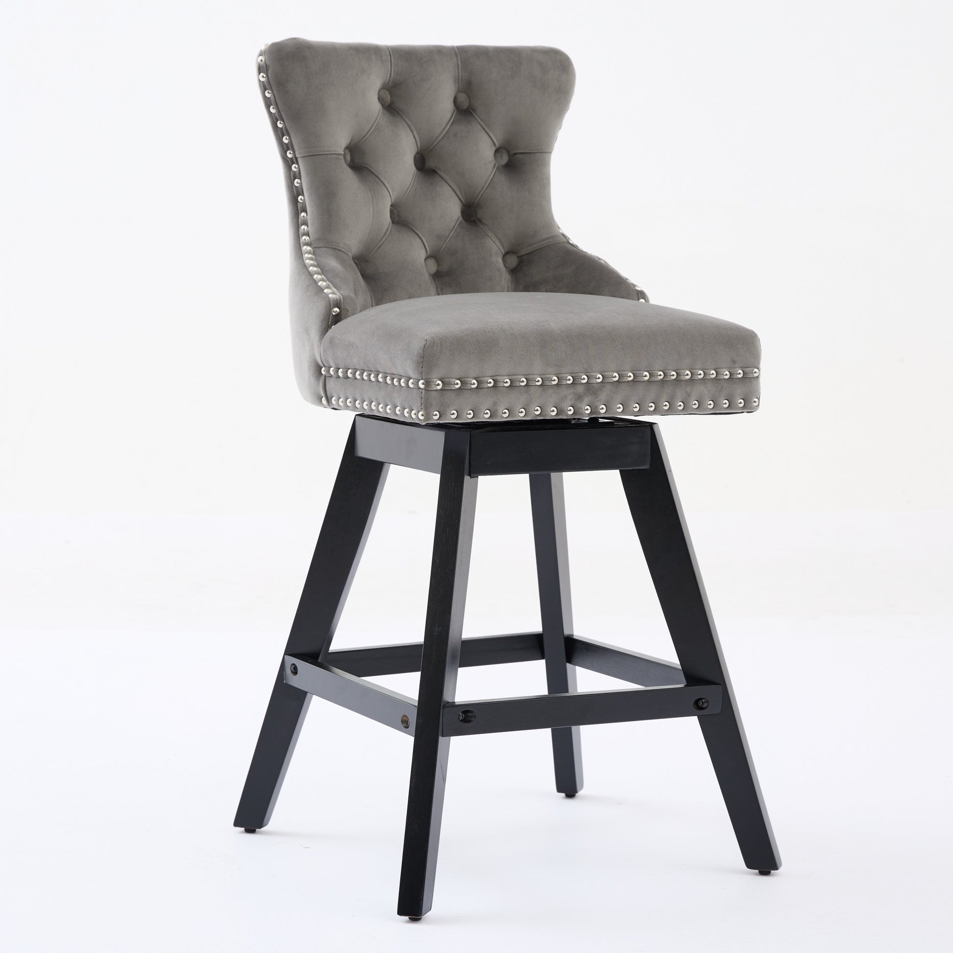 Tufted grey velvet bar stool with silver nailhead trim and black wooden base